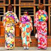 three women in front of a wooden gate wearing kimino japan painting by numbers
